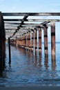 view from under the wooden pier with beach landscape and waves on the batu payung Mimiland, west kalimantan Royalty Free Stock Photo