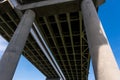 View Underneath A Large Bridge Highway On A Sunny Day With Blue Sky