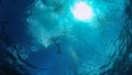 View from underwater at scuba diving marker Buoy flloating at water surface, rope hanging down, Safety Sausage for Wreck