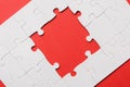 View of unfinished white jigsaw puzzles isolated on red Royalty Free Stock Photo