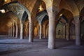 View of the unique interior architecture of Vakil Mosque with large columns and beautiful Iranian tiles, Shiraz, Iran.