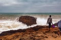 View of the unknown young people walking near stormy water of the Atlantic Ocean in the area of Essaouira in Morocco