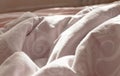 View of an unmade bed in a hotel bedroom with a crumpled sheet, duvet/duvet and pillows after waking up in the morning. Lack of Royalty Free Stock Photo