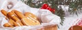 View of the unpacked christmas present with sweets against the background of a spruce branch, banner, close-up