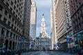 View up a deserted Broad Street ending at City Hall with the statue of William Penn. Crowds of people are behind barricades on the Royalty Free Stock Photo