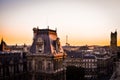 View of upper floors and rooftops of street and apartments in Paris