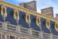 View of upper side of exterior facade of Versailles Palace with golden windows Royalty Free Stock Photo