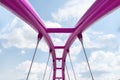 View of the upper structure of the fuchsia bridge against the blue sky