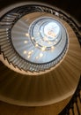 View upward spiral staircase with beautiful light