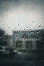 View of an urban landscape through a window is seen with droplets of rain. Royalty Free Stock Photo