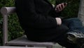 A man sits on moving bench at the `Urge to Stand` sculpture in San Francisco