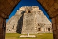 View of Uxmal palace framed by ancient stone gate