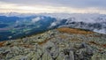 View into the valley with clouds rolling over the mountain ridge surrounding it, Low Tatras, Slovakia Royalty Free Stock Photo