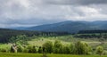 A view of the valley illuminated by a sunlit under cloudy sky