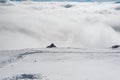 A view of the valley from the edge of a snowy slope