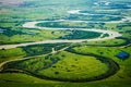 View of the valley of a meandering river among green fields and forests. Aerial photography Royalty Free Stock Photo