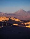 View of the Valley of the Moon in San Pedro de Atacama at sunset. In the background the volcano Licancabur and the Juriques Royalty Free Stock Photo