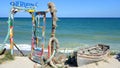 View on Vama Veche beach in Romania with distinctive image of colorful wooden door, anchor and fishermen old boat