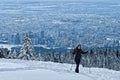 Woman hiking snowshoeing near North Vancouver on Cypress Mountain ski resort in winter.