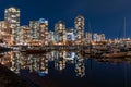 View of Vancouver downtown marina at night. Beautiful buildings skyline reflection on the water. Canada. Royalty Free Stock Photo