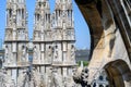 View of the various sculptures on three columns on the roof top of the Milan Cathedral with blue sky Royalty Free Stock Photo