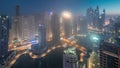 View of various skyscrapers in tallest recidential block in Dubai Marina aerial night to day timelapse Royalty Free Stock Photo