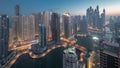 View of various skyscrapers in tallest recidential block in Dubai Marina aerial night to day timelapse Royalty Free Stock Photo