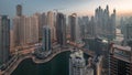 View of various skyscrapers in tallest recidential block in Dubai Marina aerial night to day timelapse Royalty Free Stock Photo