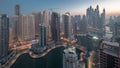 View of various skyscrapers in tallest recidential block in Dubai Marina aerial night to day timelapse Royalty Free Stock Photo