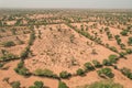 View of a vast, arid landscape featuring multiple rows of trees