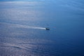 View of vast blue Aegean seascape copy space background with sailing ship and ocean water sunlight reflection from Oia village Royalty Free Stock Photo