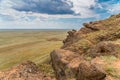 View of the vast expanses of the steppe from the side of the mountain Big Bogdo. A unique natural formation Royalty Free Stock Photo