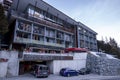 View of vehicles parked at entrance of lux alpine ski resort against sky