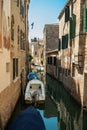 View of the Venetian canal with boats and old houses in flowers. A tourist place, journey. Venice, Italy, 08.19.2023