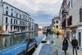 View of the Venice Canal from the street called `Fondamenta Labia` with people strolling at sunset