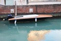 View of the Venice canal in winter, blue water and boat. Boat and motorboat on water.