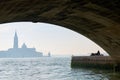 View on a Venice church with two lovers under a bridge Royalty Free Stock Photo