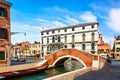 View of The Venice street and colorful houses and canal with boats and small bridge in Venice sunny day, Italy Royalty Free Stock Photo