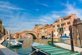 View of The Venice street and colorful houses and canal with boats and small bridge in Venice sunny day, Italy. Royalty Free Stock Photo