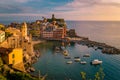 View of Vernazza one of Cinque Terre in the province of La Spezia, Italy, happy young couple picnic in the mountain with