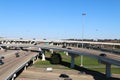 A view of a very busy interstate highway overpass exchange with multiple lanes of freeway traffic and a bright blue sky Royalty Free Stock Photo