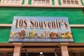 View of vibrant painting above the entrance of a souvenir shop featuring inexpensive goods, depicting the colorful facade