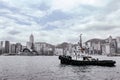 The view of Victoria Harbour, Hong Kong from the coast with a tugboat. Royalty Free Stock Photo