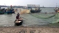 View of Vietnamese fishermen and their boat aproaching to the dockside, Da Nang
