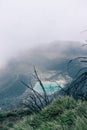 View of the viewpoint of the Turrialba Volcano National Park where you can see a turquoise volcanic lagoon on a foggy day near the
