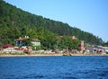 View of the village of Listvyanka from the lake Baikal. On the beach residential buildings hotels and many tourists