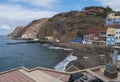 view of village Puerto de Sardina del Norte with sand beach, coastal cliffs, marina and colorful houses. Grand Canaria Royalty Free Stock Photo