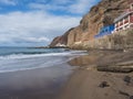 view of village Puerto de Sardina del Norte with sand beach, coastal cliffs, marina and colorful houses. Grand Canaria Royalty Free Stock Photo