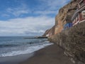 View of village Puerto de Sardina del Norte with sand beach, coastal cliffs, marina and colorful houses. Grand Canaria, Canary Royalty Free Stock Photo