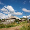 View of the village street with old wooden house. Village of Visim, Sverdlovsk region, Russia Royalty Free Stock Photo